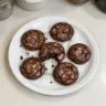 Gourmet brownie cookies stacked on a plate, showcasing their rich chocolate texture