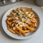 Delicious Louisiana Voodoo Fries topped with spices and sauces.