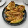 Miso Butter Roasted Cabbage Wedges served on a plate with garnishes.