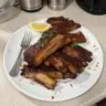 Delicious oven-to-grill ribs ready to serve, showcasing juicy meat and rich flavors.