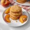 Freshly baked peach cookies on a cooling rack, showcasing their golden color.