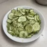 Salt and vinegar cucumber chips served in a bowl, a healthy snack option.