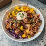 Delicious spicy jerk chicken served with colorful mango slaw.