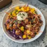 Delicious spicy jerk chicken served with colorful mango slaw.