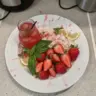 Glass of strawberry basil lemonade garnished with fresh basil leaves