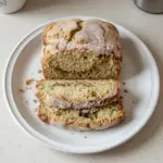 Slice of snickerdoodle zucchini bread topped with cinnamon sugar