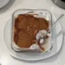 Delicious tiramisu chia pudding served in a glass topped with cocoa powder and coffee beans.