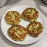 Crispy Zucchini Fritters served on a plate with dipping sauce