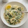 Delicious lemon ricotta pasta with spinach ready to be served in a bowl.