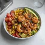 Avocado Corn Salad with Grilled Shrimp served in a colorful bowl