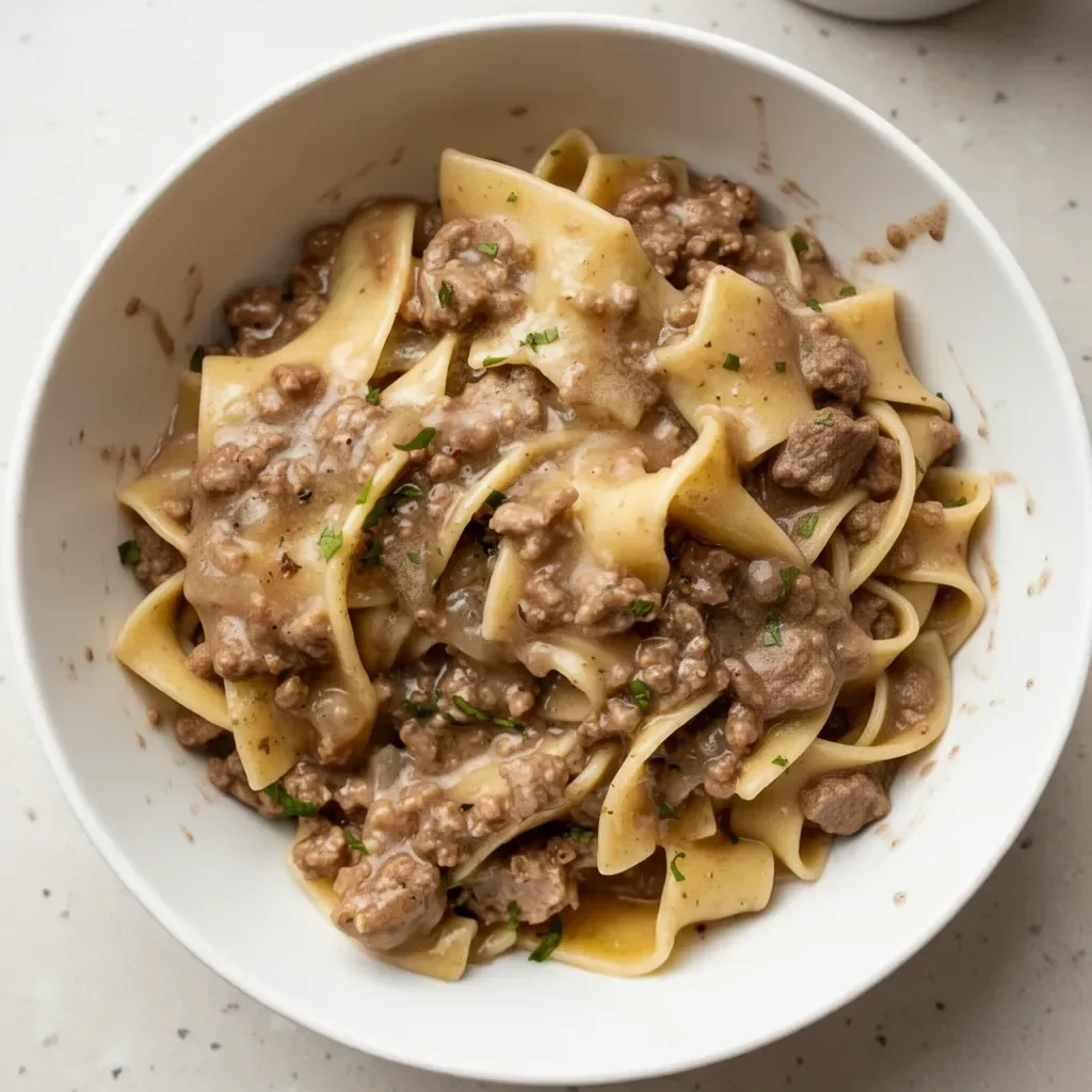 Delicious plate of beef and noodles garnished with herbs