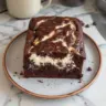 Slice of chocolate zucchini bread with cream cheese filling on a wooden board