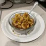 Cinnamon maple chia seed pudding with bananas foster topping served in a bowl.