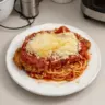 Plate of classic chicken parmesan topped with marinara sauce and cheese