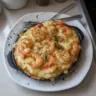 Delicious garlic shrimp gratin topped with herbs and cheese