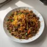 Bowl of Easy Mongolian Ground Beef Noodles with vegetables and sauce