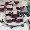 Glazed blueberry brownies topped with a sweet glaze and fresh blueberries
