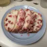 Freshly baked glazed strawberry bread with strawberries on top