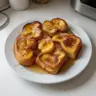 Delicious Hawaiian Roll French Toast topped with syrup and berries