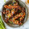 Juicy Honey Garlic Chicken Skewers served on a plate with garnishes.