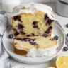 Sliced Lemon Blueberry Pound Cake with fresh blueberries and lemon zest