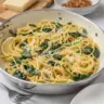 Delicious bowl of Lemon Spinach Pasta garnished with fresh herbs