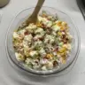 Delicious loaded baked potato salad topped with cheese and green onions.
