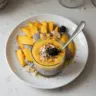 Delicious mango chia pudding topped with fresh mango slices and mint leaves