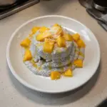 Delicious mango coconut chia pudding in a bowl with fresh mango slices on top