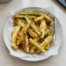 Crispy Parmesan Zucchini Fries served on a plate with dipping sauce