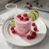 Refreshing Raspberry Coconut Margarita with vibrant raspberries and coconut garnish