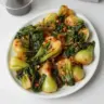 Plate of Spicy Garlic Bok Choy sautéed with seasoned garlic.