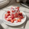 Strawberries and Cream Cocktail in a glass with fresh strawberries on the side