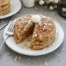 Toasted coconut pancakes topped with coconut cream and flakes
