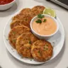 Golden brown tuna patties served with salad on a white plate