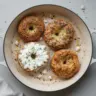 Baked protein bagels with cottage cheese on a wooden table