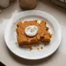 High-protein pumpkin breakfast cake topped with pumpkin seeds and spices