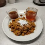 Homemade pumpkin spice syrup in a glass bottle with spices