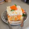 Deliciously layered Orange Creamsicle Cake with creamy orange frosting and zest.
