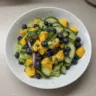 Mango Cucumber Salad topped with blueberries and creamy avocado for a refreshing dish